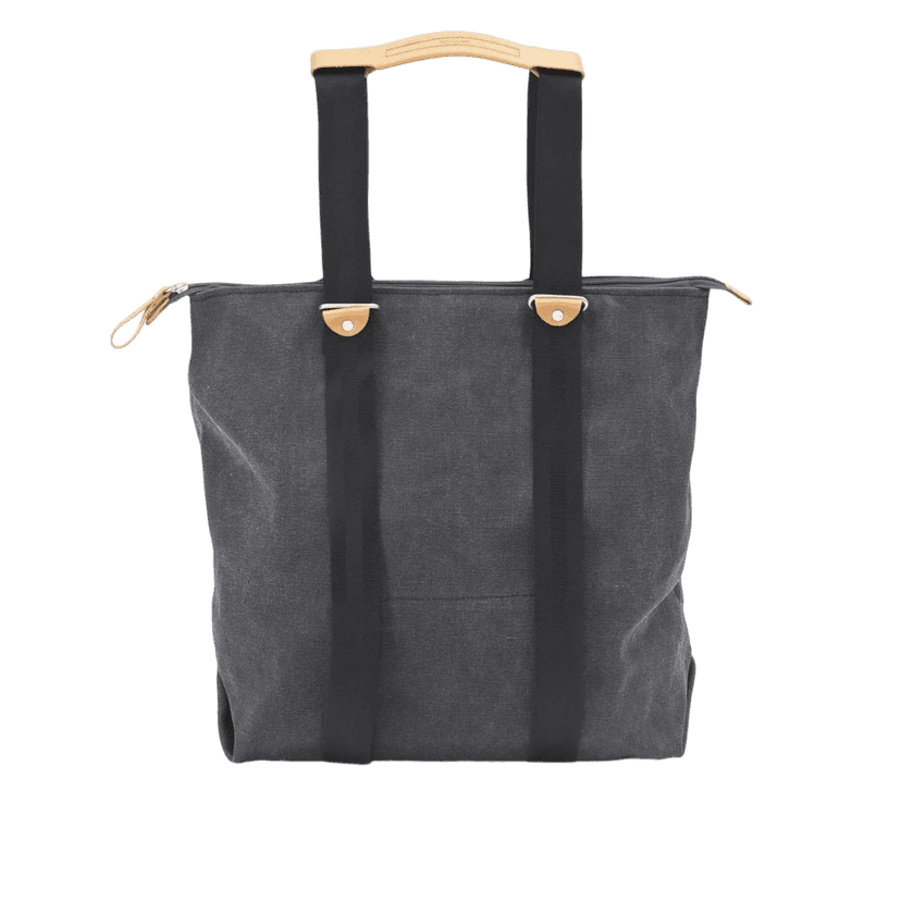 Tote bag with washed black canvas body and tan leather handles.